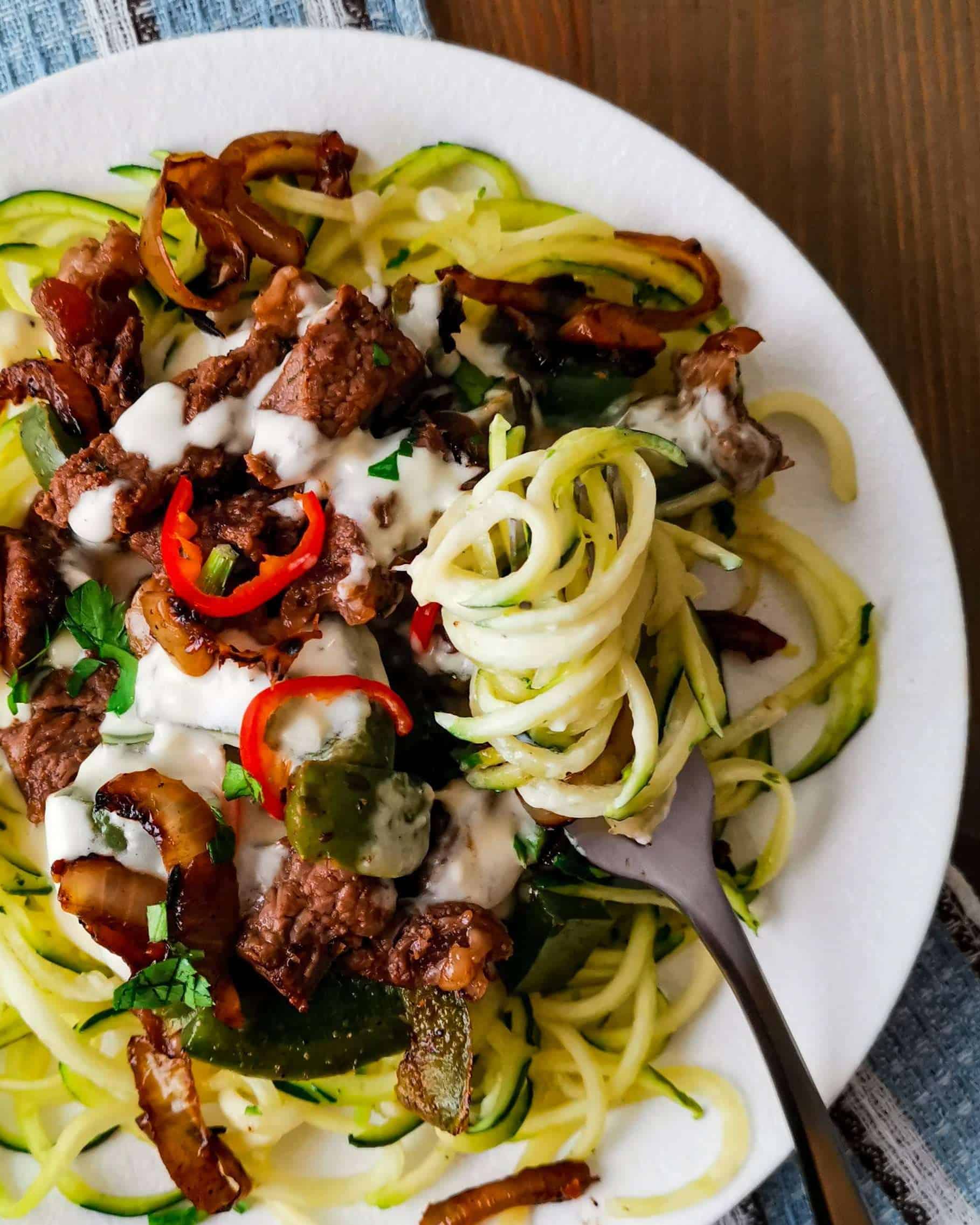 Low carb Philly cheesesteak zoodles on a fork