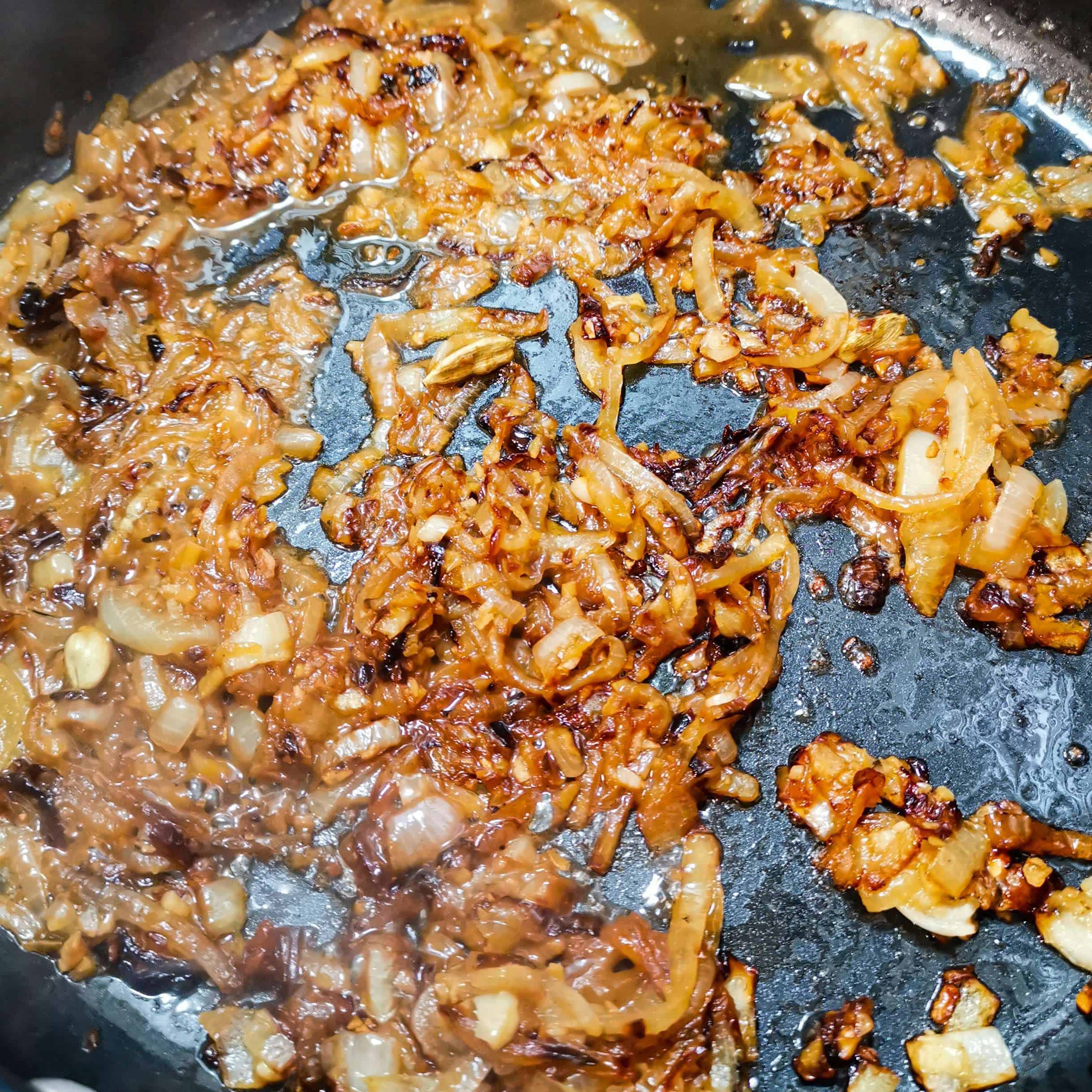 Onions in a pan water frying for a curry
