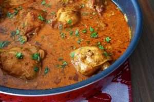 Keto friendly Indian chicken curry in a red pot