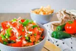 Keto Pico de Gallo ina bowl with pork rinds and other ingredients