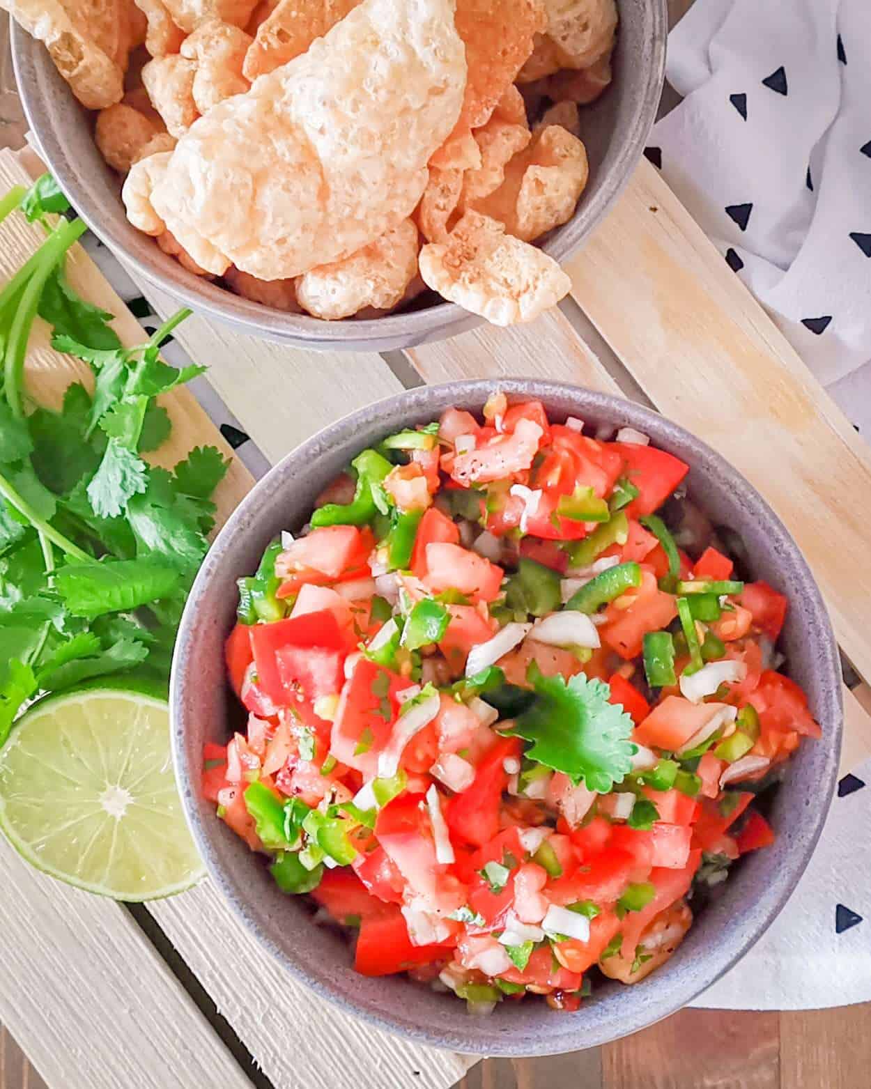 Keto Pico De gallo in a bowl with pork rinds for dipping