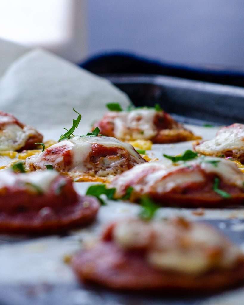Low Carb Mini Salami crust pizzas on a baking tray