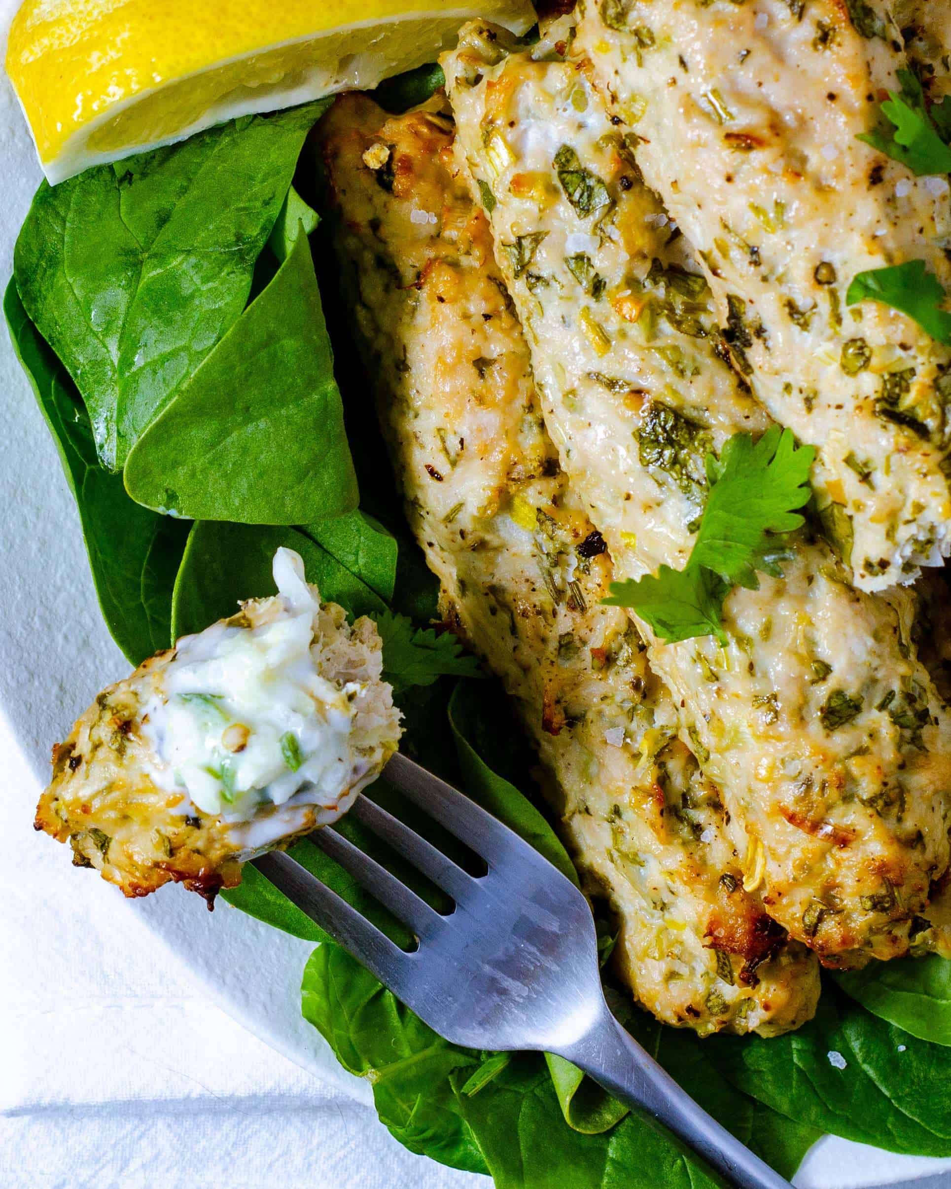 Low carb chicken kebab on a fork with raita