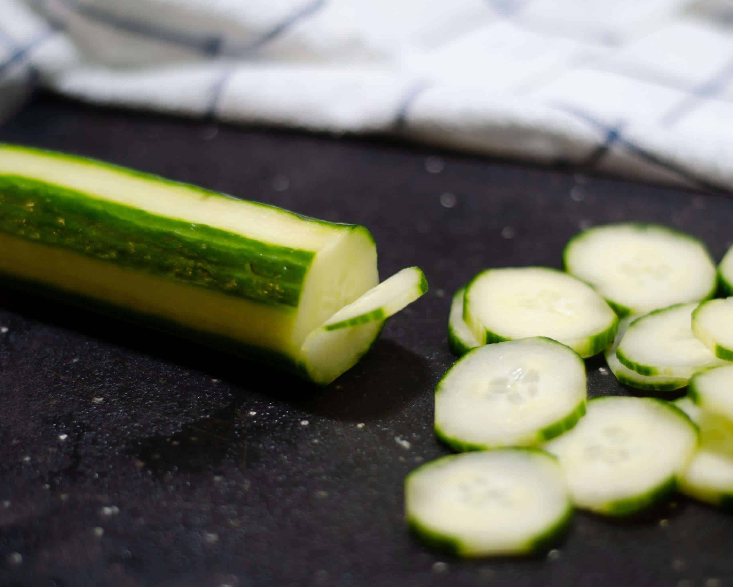 Cucumber being thinly sliced for Creamy Keto Cucumber Salad