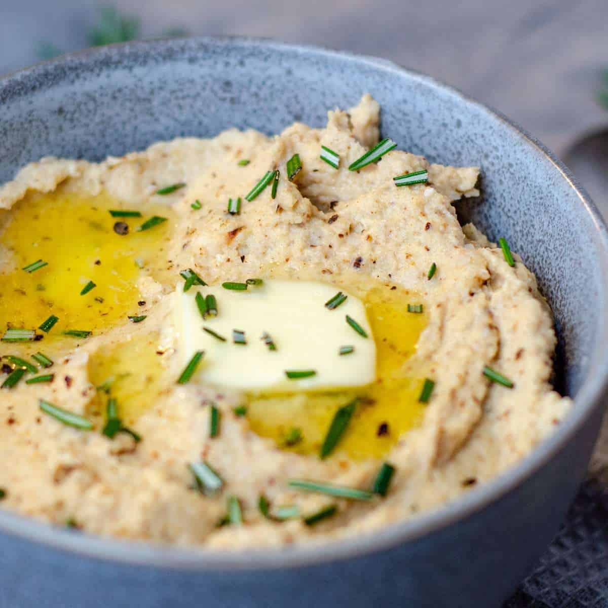 Cauliflower mash topped with rosemary and melted butter