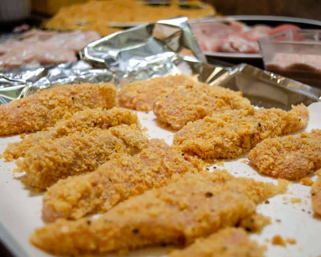 Pork Rind Coated Chicken Strips ready for the oven