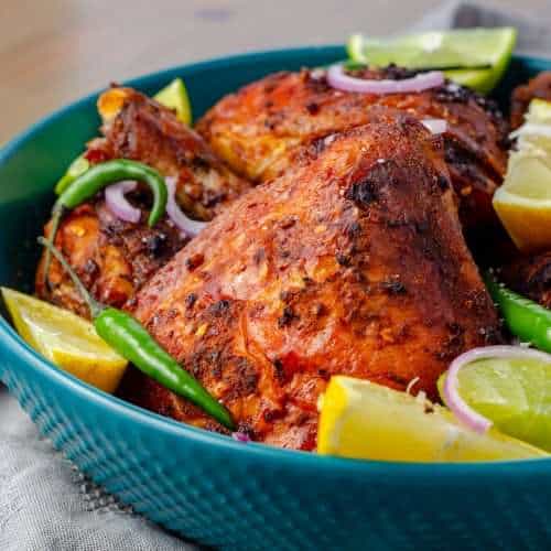 A platter of garnished low carb peri peri chicken
