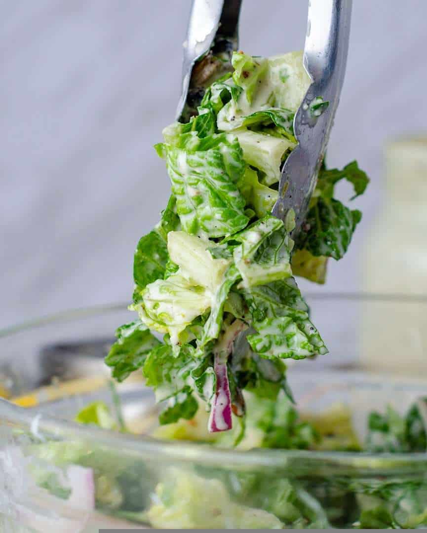 Keto Caesar salad served with tongs