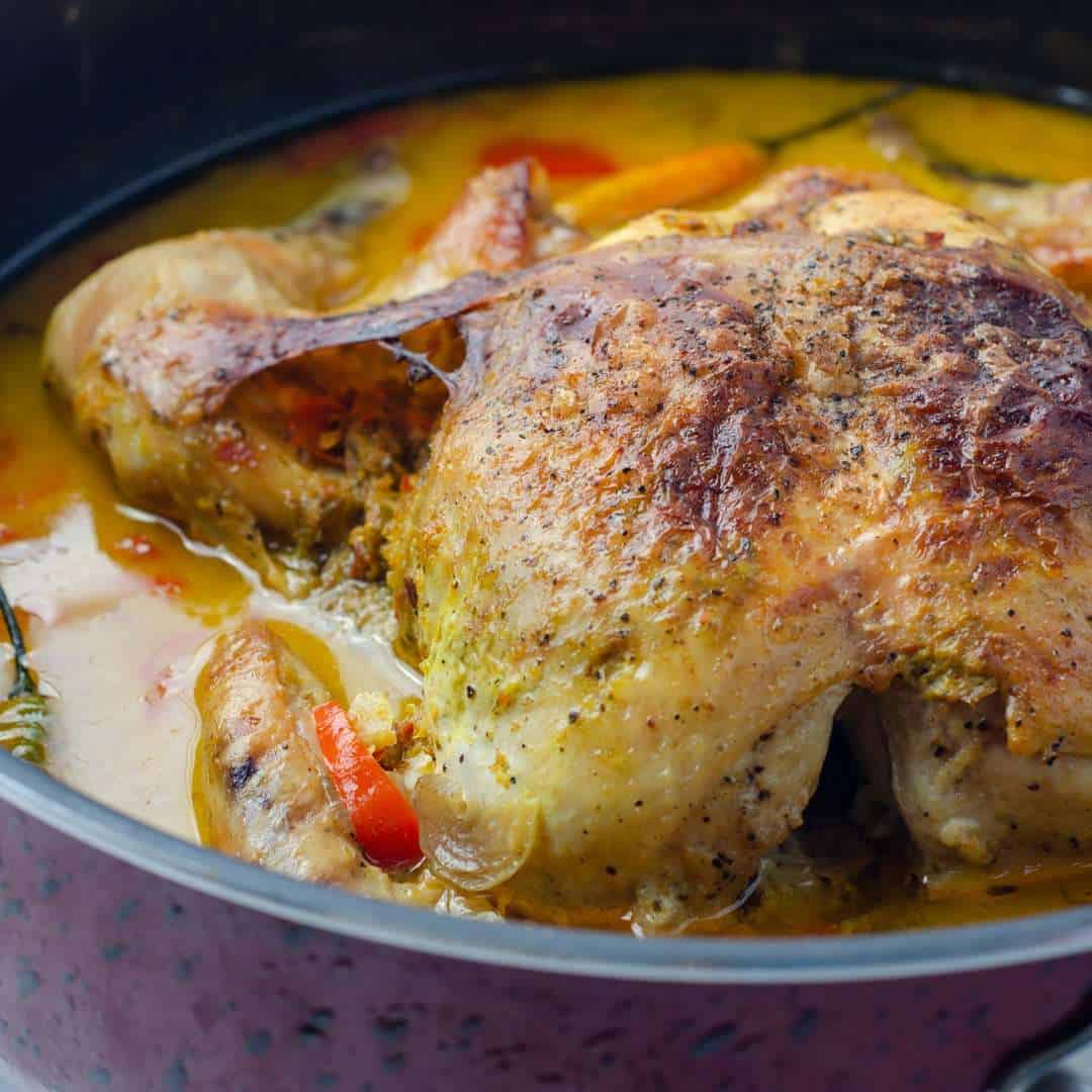 Coconut Milk Braised Chicken on a pan with gravy