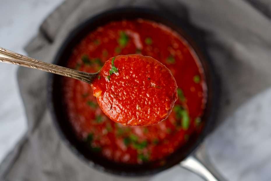 Low Carb Marinara on a spoon over a pot