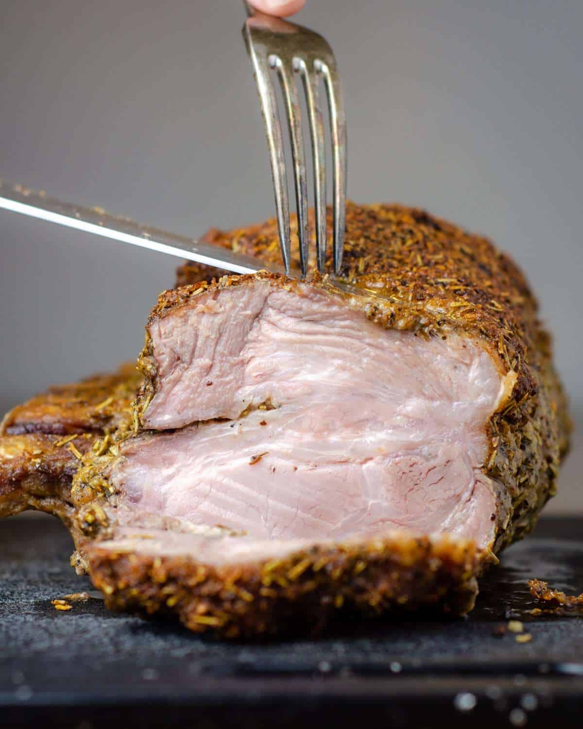 Perfectly oven roasted pork center loin roast being sliced
