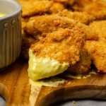 Keto chicken finger dipped in low carb honey mustard
