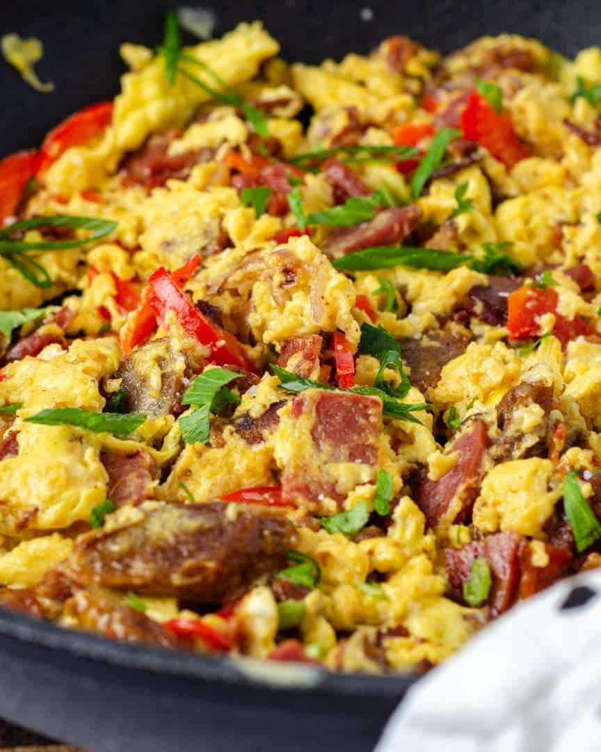 Protein keto scrambled eggs garnished in a frying pan
