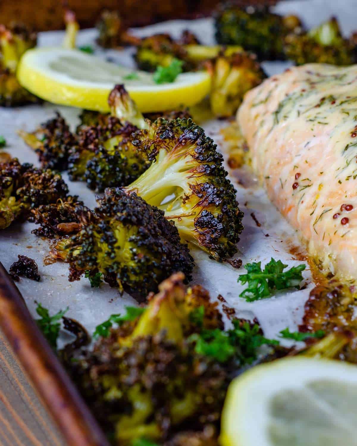 Crispy oven roasted broccoli with salmon on a pan