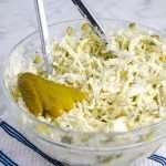 Easy Dill Pickle Keto coleslaw in a bowl with tongs
