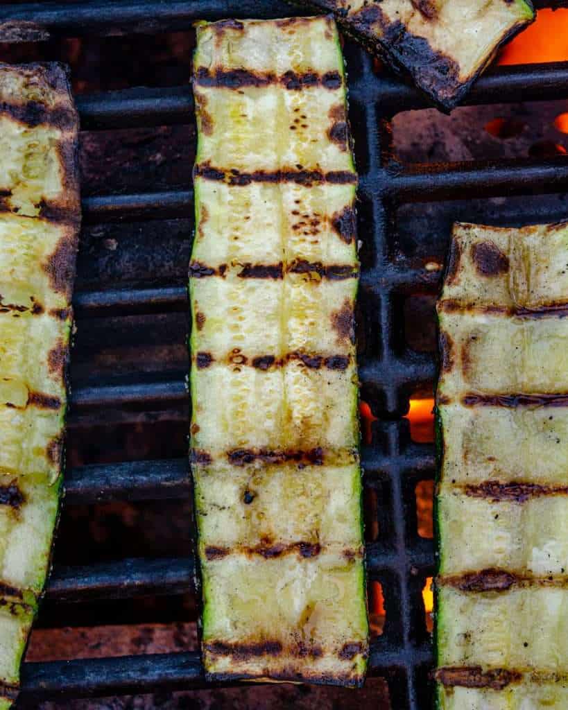 Slabs of sliced zucchini on a grill