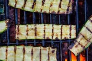 Slices of zucchini on a BBQ grill