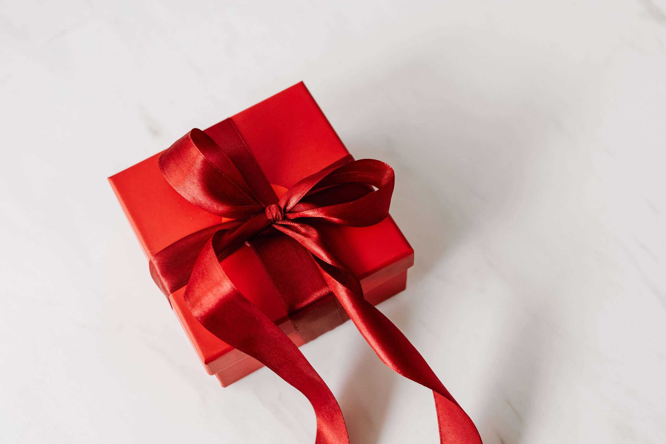 A red gift box on a white background