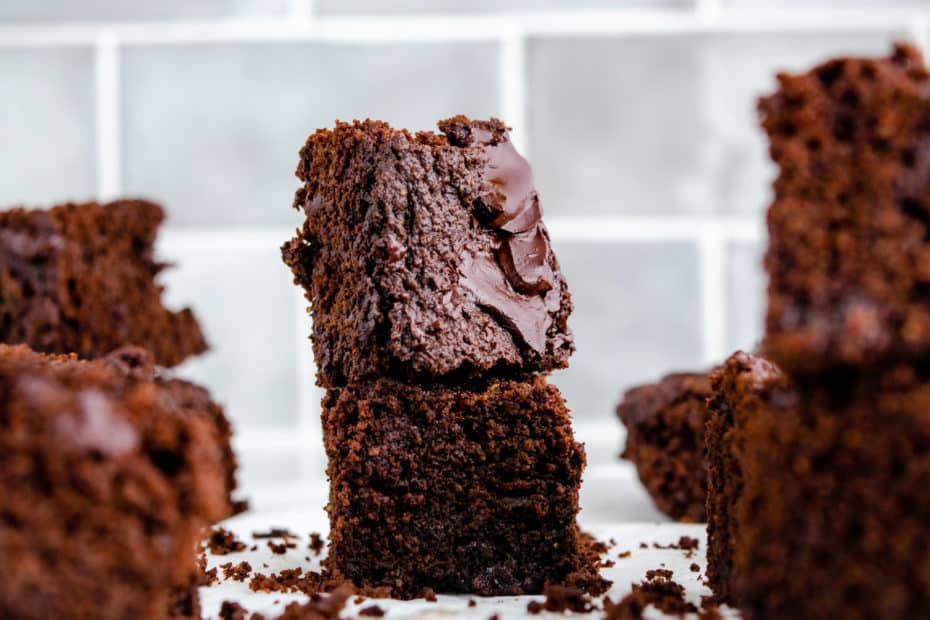 A pile of keto two bite brownie on grey tile backdrop