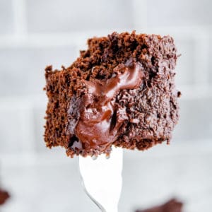 Keto two bite brownie with a bite out of it on a fork