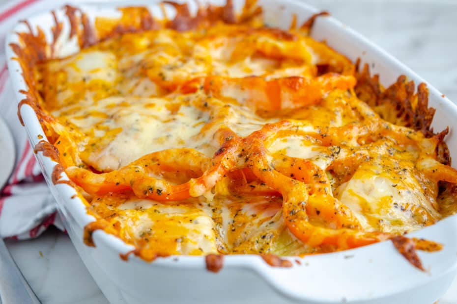 Cheesy vegetable casserole in a white dish