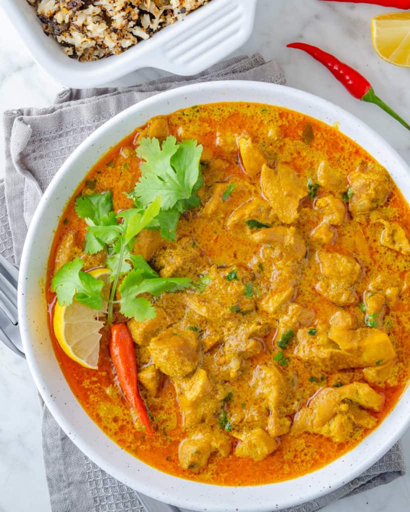 Low carb yellow chicken curry in a white bowl from above
