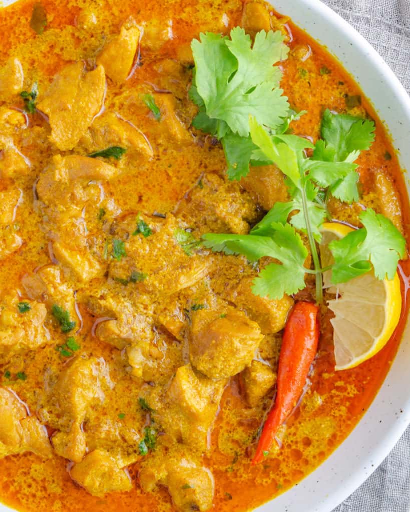 Yellow chicken curry in a bowl from above