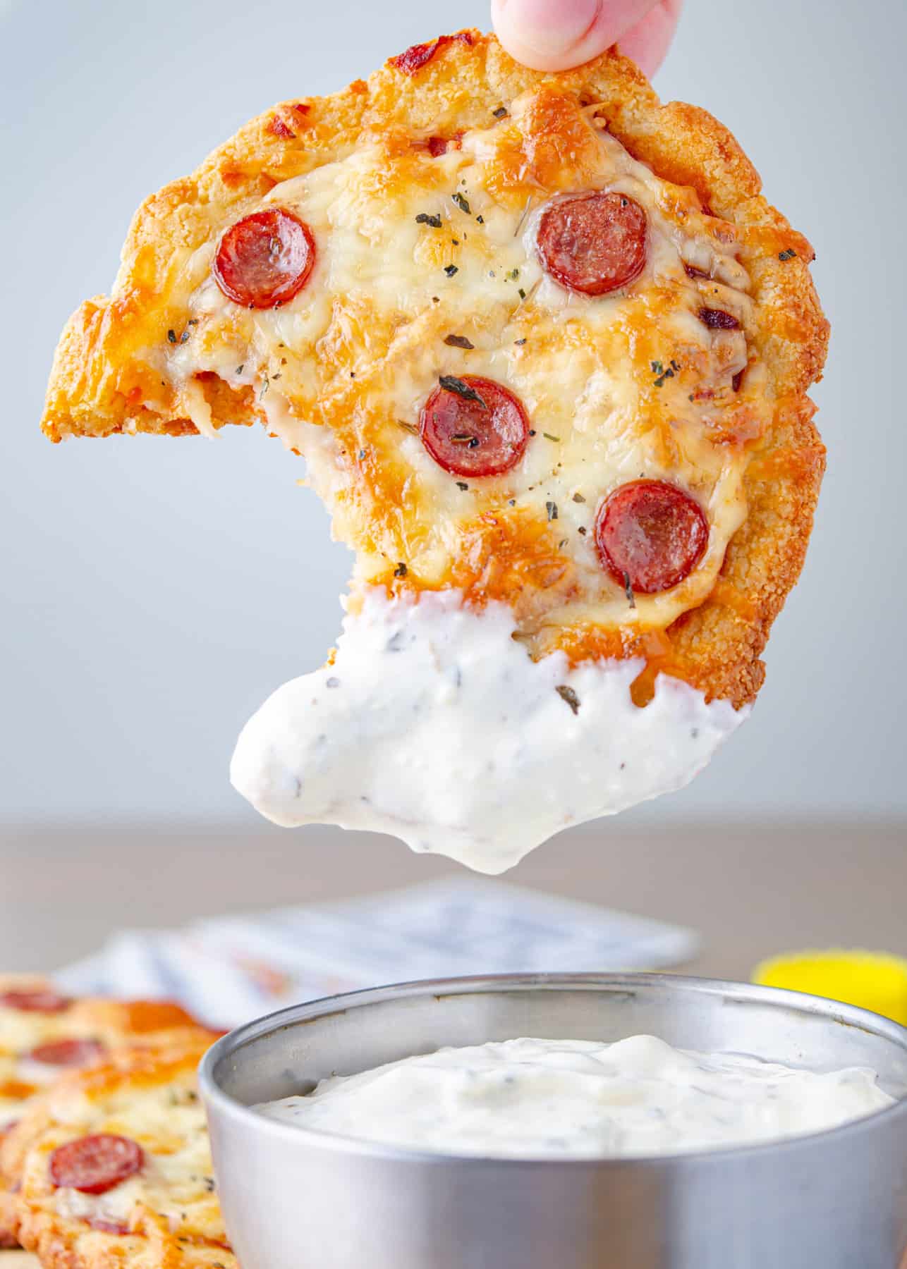 Low carb mini pizzas dipped in creamy garlic dipping sauce