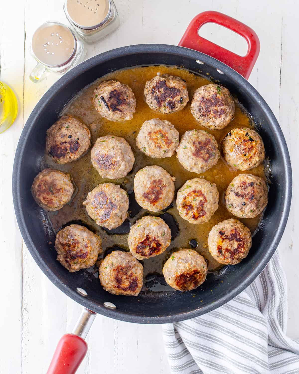 Cooking Italian meatballs in a large pan
