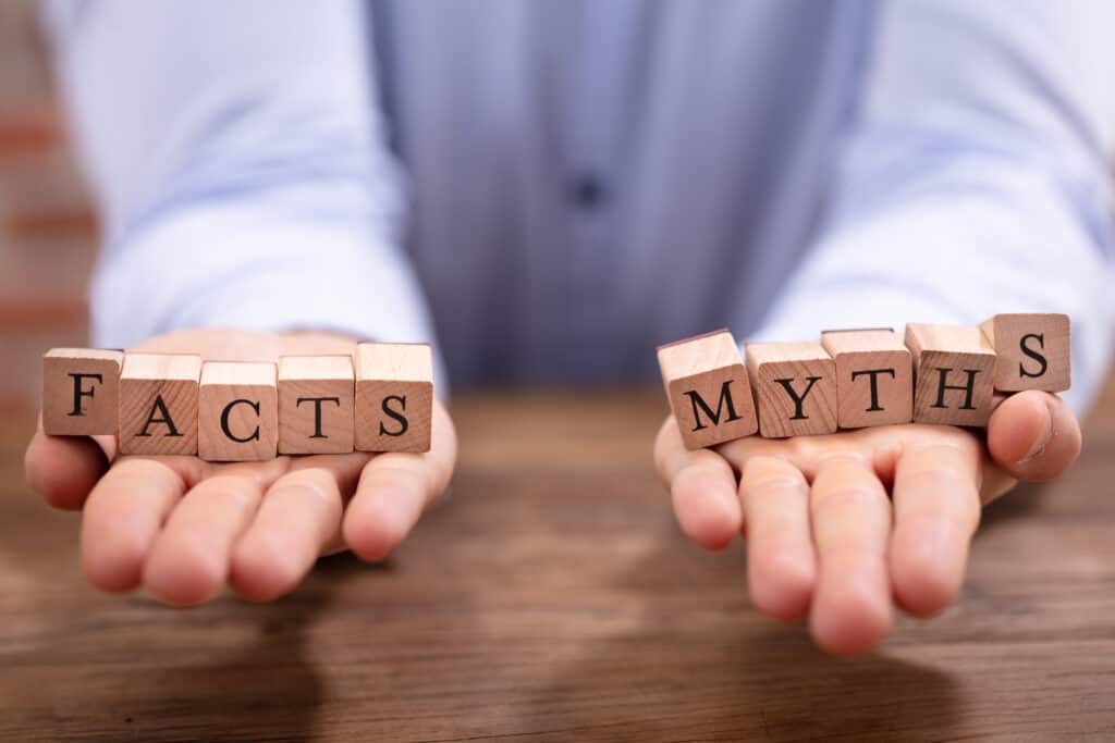 Man holding letter blacks that spell out Facts and Myths