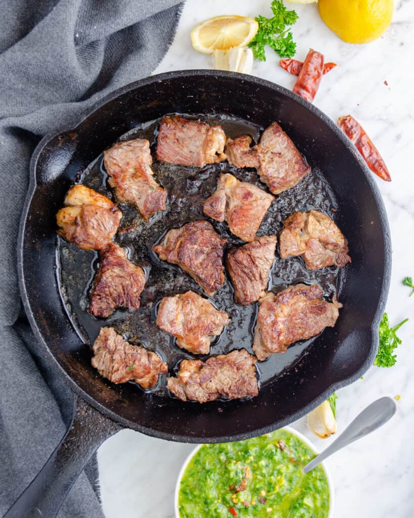 Steak bites perfectly seared in a cast iron pan