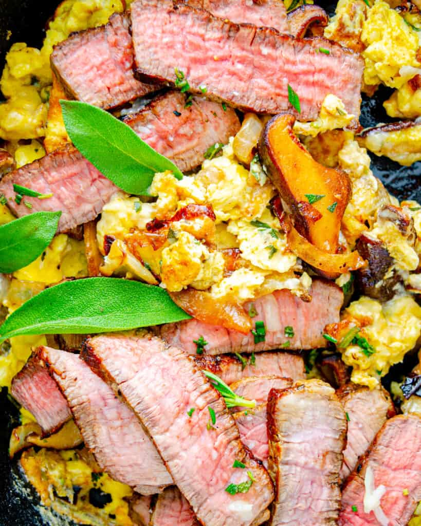 Fluffy scrambled eggs with swiss cheese, mushrooms and steak.