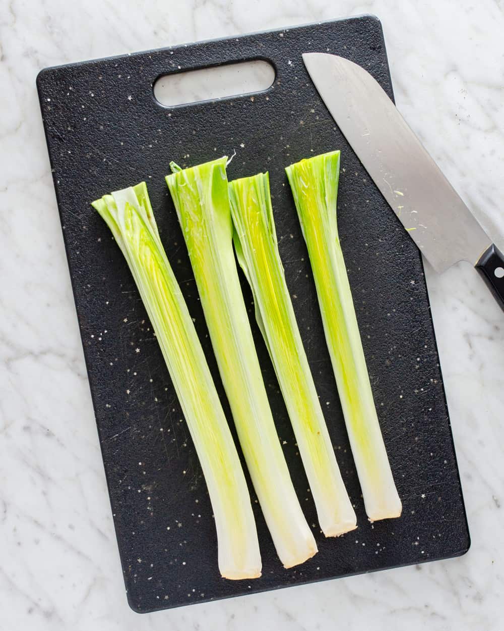 How to clean leeks - Leeks sliced in half lengthwise to clean out the dirt.