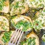 Pan seared chicken bites in a cast iron skillet covered in gremolata.