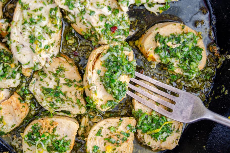 Pan seared chicken bites in a cast iron skillet covered in gremolata.